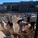 (Funeral workers bury migrants who died while trying to cross from Morocco into the Spanish exclave of Ceuta, on Friday.  AP Photo: Antonio Sempere)