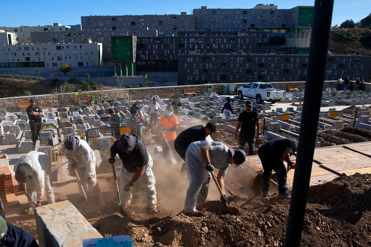 (Funeral workers bury migrants who died while trying to cross from Morocco into the Spanish exclave of Ceuta, on Friday.  AP Photo: Antonio Sempere)