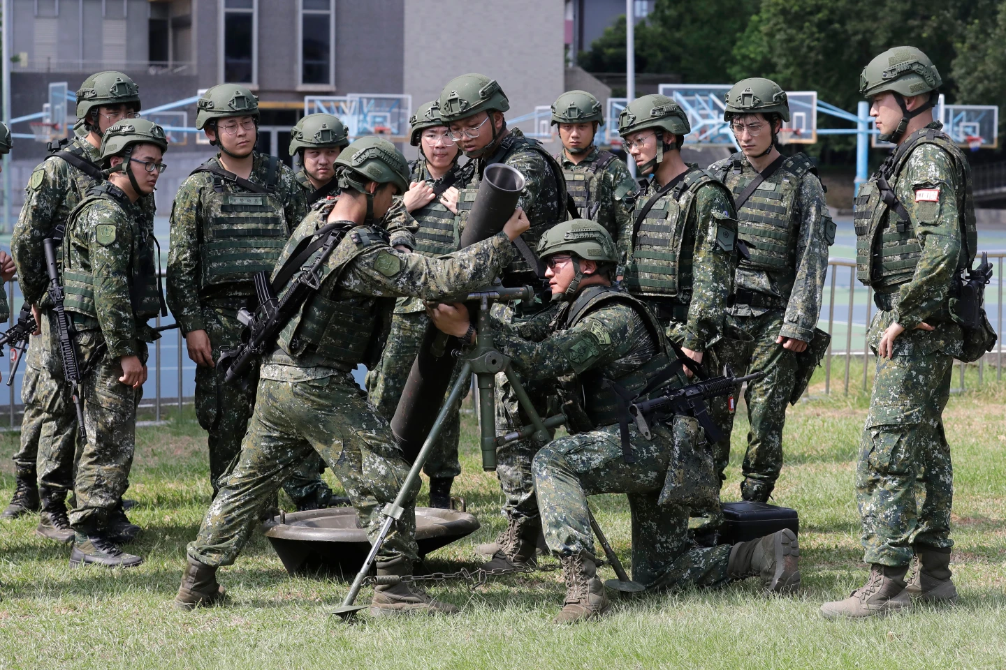 (Soldiers conduct team training on a mortar during the annual Han Kuang military exercises in Taipei, Taiwan, Wednesday, Aug. 5, 2026. AP Photo: Chiang Ying-ying)