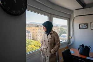 (Wesam Hamada, the mother of Hind Rajab, a Palestinian girl who was killed in Gaza City in January 2024 after the car she was in with relatives came under Israeli fire, looks out a window at an office building at an undisclosed location, Friday, Aug. 21, 2026.  AP Photo: Giannis Papanikos)