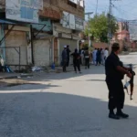 (In this photo taken with a smartphone, police officers secure a road leading to the site of a powerful bomb at a mosque in Kohat, Pakistan, Friday, Sept. 18, 2026. AP Photo: B.S. Gillani)