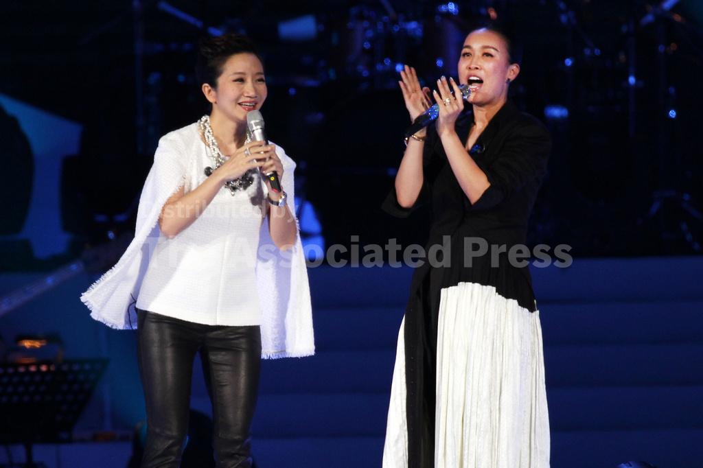  (Chinese singer Na Ying, right, and Taiwanese singer Matilda Tao performs during an public welfare Concert for abused girls at the Taipei Arena in Taipei, Taiwan, April 20, 2014. (AP File Photo: Chiang Ying-ying)