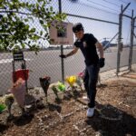 (A person adjusts flowers at a memorial for Eliana Moreno and George Marciniw, who died in a helicopter crash the day prior while covering an accident for a television station, at the site where their helicopter used to park at Whiteman Airport in Los Angeles, Wednesday, Sept. 16, 2026. (AP Photo/Ethan Swope) ADDITION: Adds in a helicopter crash the day prior while covering an accident for a television station. AP Photo: Ethan Swope)