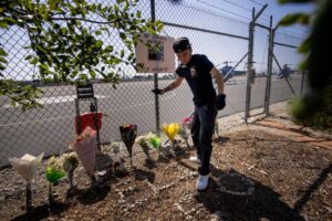 (A person adjusts flowers at a memorial for Eliana Moreno and George Marciniw, who died in a helicopter crash the day prior while covering an accident for a television station, at the site where their helicopter used to park at Whiteman Airport in Los Angeles, Wednesday, Sept. 16, 2026. (AP Photo/Ethan Swope) ADDITION: Adds in a helicopter crash the day prior while covering an accident for a television station. AP Photo: Ethan Swope)