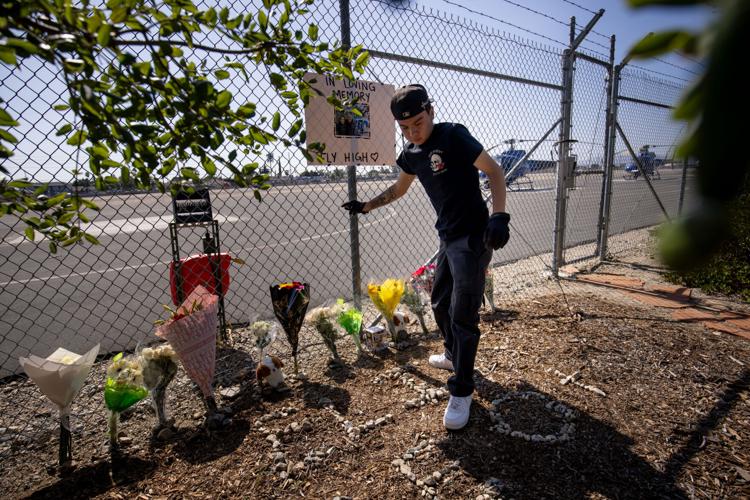 (A person adjusts flowers at a memorial for Eliana Moreno and George Marciniw, who died in a helicopter crash the day prior while covering an accident for a television station, at the site where their helicopter used to park at Whiteman Airport in Los Angeles, Wednesday, Sept. 16, 2026. (AP Photo/Ethan Swope) ADDITION: Adds in a helicopter crash the day prior while covering an accident for a television station. AP Photo: Ethan Swope)