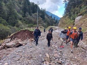 (Chief District Officer Kopila Rai and others inspecting the damaged road. Photo: District Administration Office, Rukum East)