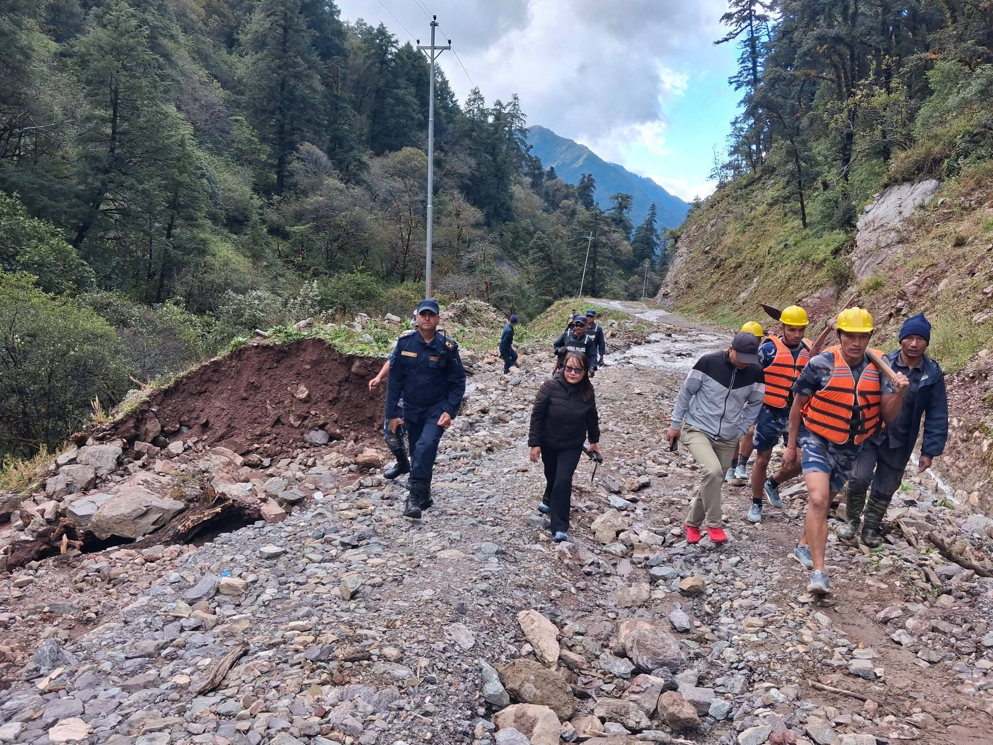 (Chief District Officer Kopila Rai and others inspecting the damaged road. Photo: District Administration Office, Rukum East)