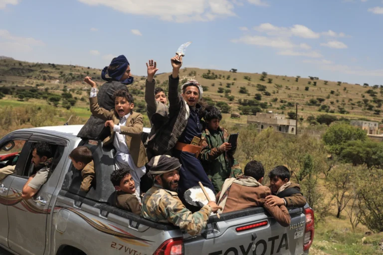 (Yemeni civilians celebrate while riding in the back of a pickup truck in the Bani Matar district, Yemen, Saturday, Sept. 12, 2026, as they follow a convoy carrying Houthi prisoners freed in Mokha on its way to Sanaa following the Houthi takeover of the southern Red Sea port city. Credit: AP-STR)