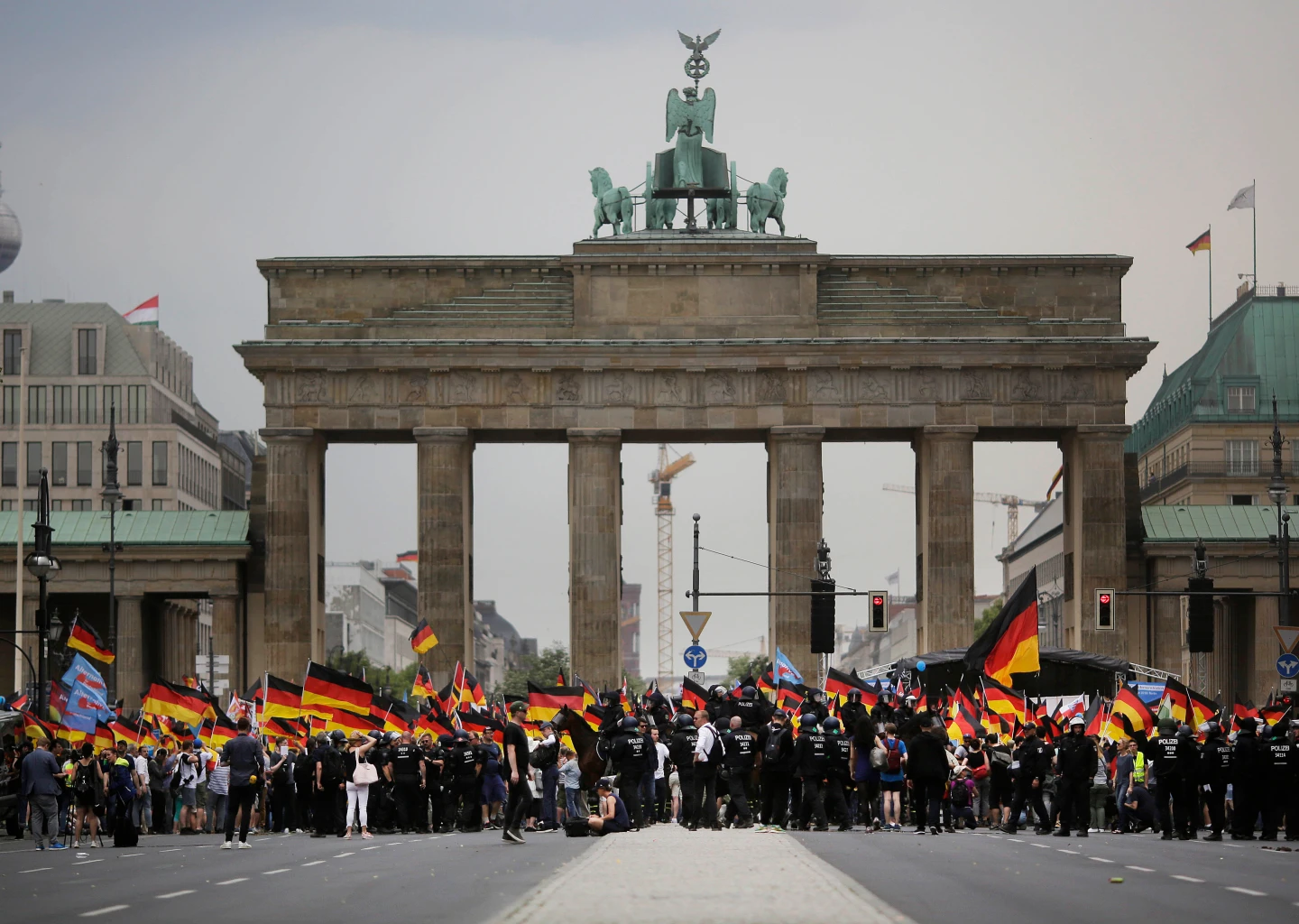 (AfD supporters wave AfD flags and German national flags during a demonstration in front of the Brandenburg Gate in Berlin, Germany, May 27, 2018. AP Photo: Markus Schreiber, File)