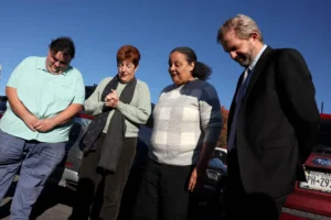 (Dale Avers, second left, offers a prayer for Marva Cook, second from right, outside the U.S. Immigration and Customs Enforcement (ICE) office in Syracuse, N.Y., on Wednesday, Oct. 21, 2026. Photo: Dennis Nett: The Post-Standard via AP)