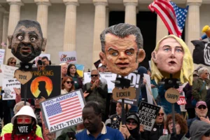 (Demonstrators rally at the Lincoln Memorial during a "No Kings" protest in Washington, Saturday Oct. 17, 2026. AP Photo: Jose Luis Magana)