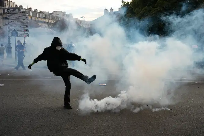 (A protesters kicks a teargas canister during scuffles following a demonstration against under-resourced schools, in Paris, Tuesday, Oct. 6, 2026.  AP Photo: Teresa Suarez)