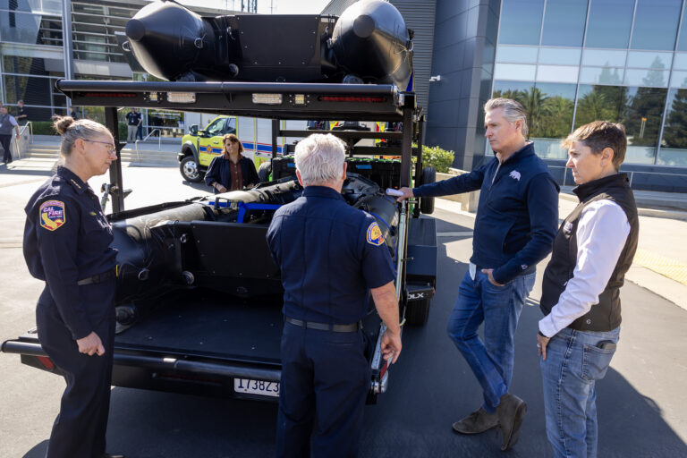 (Governor Gavin Newsom and Cal OES Director Caroline Thomas Jacobs receive a hands-on briefing in Mather on new swiftwater rescue vehicles and equipment to strengthen California’s storm preparedness. Photo: Governor Office)