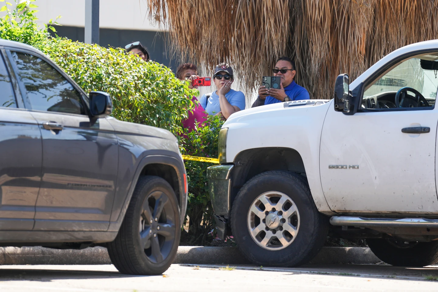 (People watch as Harris County Sheriff deputies work the scene near two vehicles involved after a man was struck by an ICE agent's vehicle during an immigration enforcement operation in northwest Houston, Saturday, Oct. 10, 2026.  Photo: 9Jason Fochtman-Houston Chronicle via AP)