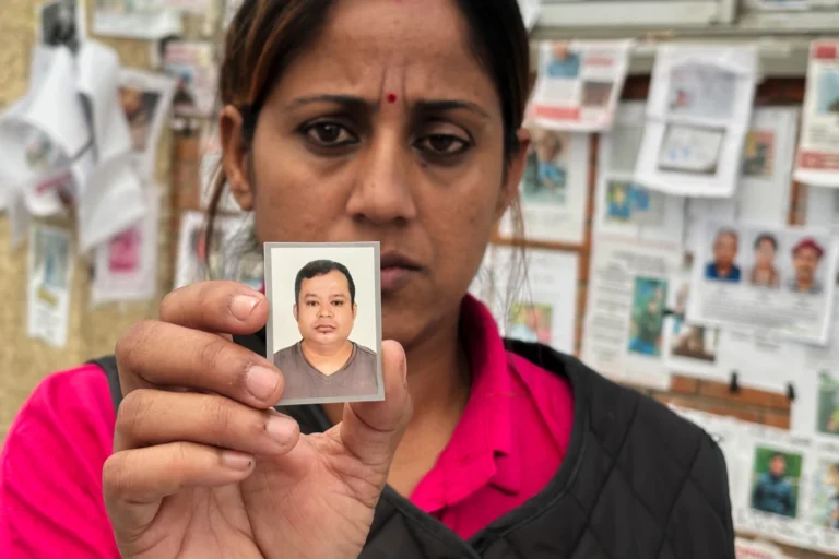 (In this photo taken with a smartphone, Usha Khatri shows a photo of her husband Indra Bahadur who has been missing since last month's flood outside Tribhuvan University Teaching Hospital, in Kathmandu, Nepal, Thursday, Sept. 17, 2026.  AP photo: Upendra Man Singh)
