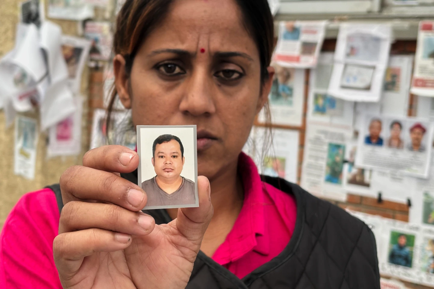 (In this photo taken with a smartphone, Usha Khatri shows a photo of her husband Indra Bahadur who has been missing since last month's flood outside Tribhuvan University Teaching Hospital, in Kathmandu, Nepal, Thursday, Sept. 17, 2026.  AP photo: Upendra Man Singh)