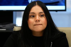 (Marimar Martinez, a Chicago woman who was shot by a Border Patrol agent last year, listens to attorney Christopher Parente at a press conference Monday, Oct. 5, 2026, in Chicago. (AP Photo/Nam Y. Huh) AP Photo: Nam Y. Huh)