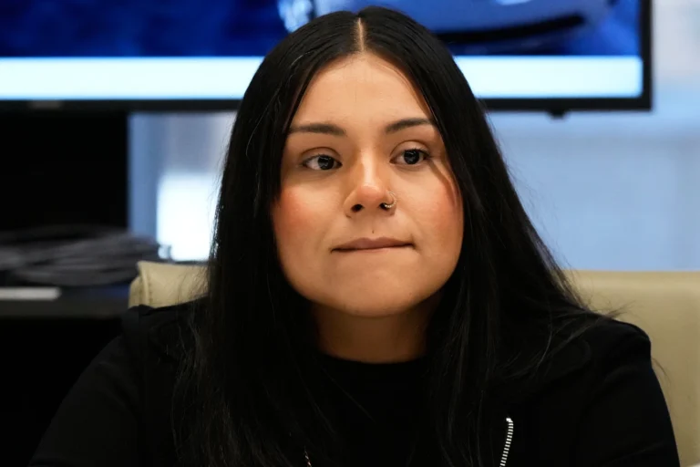 (Marimar Martinez, a Chicago woman who was shot by a Border Patrol agent last year, listens to attorney Christopher Parente at a press conference Monday, Oct. 5, 2026, in Chicago. (AP Photo/Nam Y. Huh) AP Photo: Nam Y. Huh)