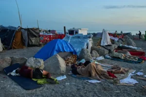 (Migrants, some of them minors, sleep on El Trampolín Beach in the Spanish enclave of Ceuta, Thursday, Oct. 1, 2026.  AP Photo: Bernat Armangue)