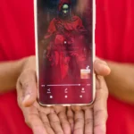 (A Moroccan TikToker whose asylum application was denied shows his social media profile during an interview with The Associated Press on El Trampolín Beach in the Spanish enclave of Ceuta, Friday, Oct. 2, 2026.  AP Photo: Bernat Armangue)