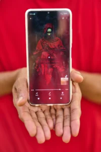 (A Moroccan TikToker whose asylum application was denied shows his social media profile during an interview with The Associated Press on El Trampolín Beach in the Spanish enclave of Ceuta, Friday, Oct. 2, 2026.  AP Photo: Bernat Armangue)