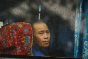 (One of Myanmar nationals looks out from a bus in Manjung, Perak state of Malaysia, on Tuesday, Sept. 29, 2026.  AP Photo: Vincent Thian)