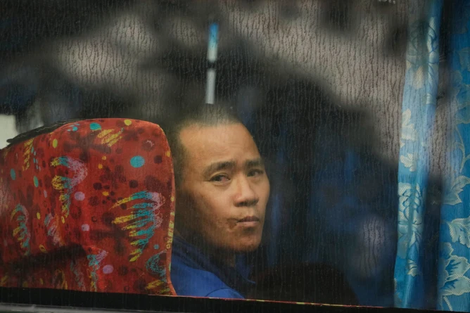 (One of Myanmar nationals looks out from a bus in Manjung, Perak state of Malaysia, on Tuesday, Sept. 29, 2026.  AP Photo: Vincent Thian)