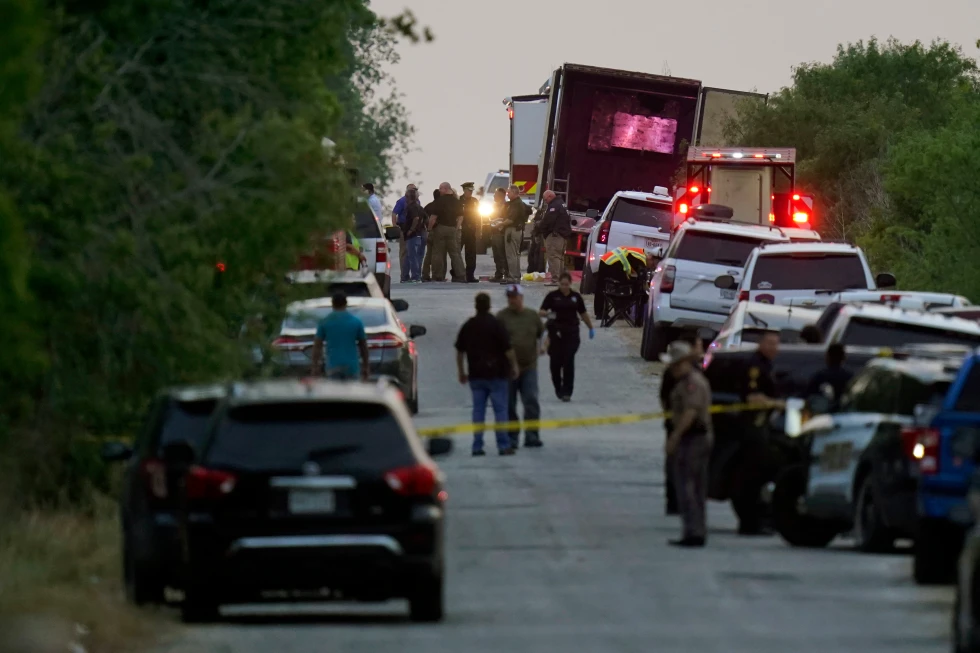 (Police and other first responders work the scene where officials say dozens of people have been found dead and multiple others were taken to hospitals with heat-related illnesses after a tractor-trailer containing suspected migrants was found on June 27, 2022, in San Antonio.  AP File Photo: Eric Gay)