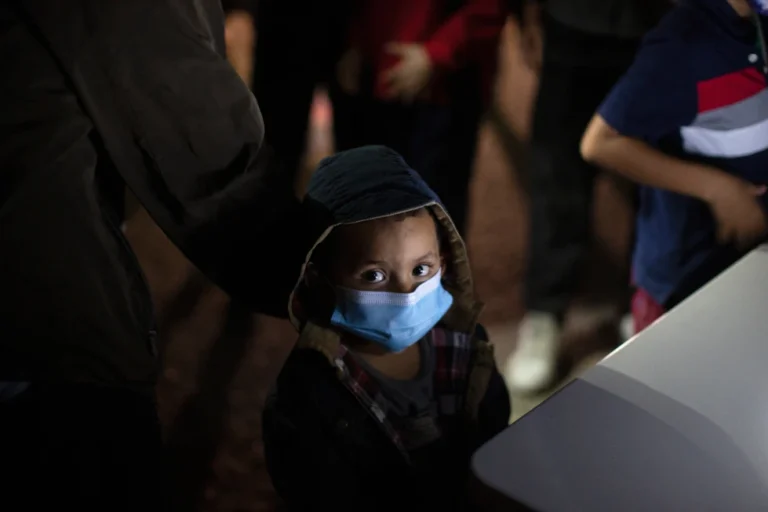 (An unaccompanied minor looks up as he waits to answer questions from a U.S. Border Patrol agent at an intake site after he was smuggled on an inflatable raft across the Rio Grande River, March 24, 2021, in Roma, Texas. (AP File Photo: Dario Lopez-Mills)