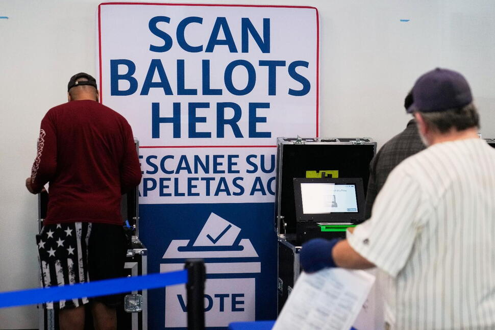 (Voters scan their ballots at early in-person voting in Cleveland, Wednesday, Oct. 7, 2026.  AP Photo: Sue Ogrocki)