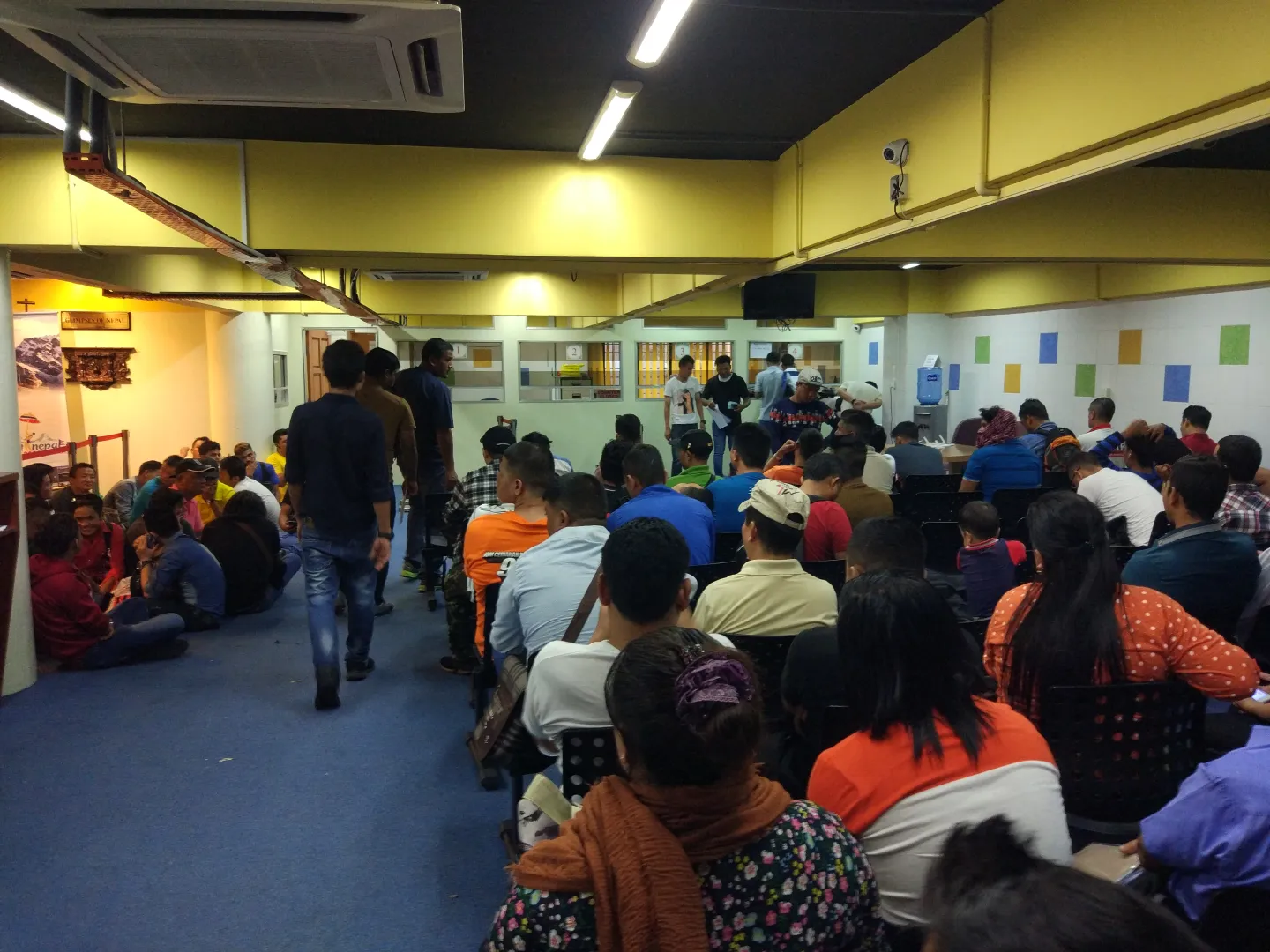 (Nepali migrant workers waiting for their turn at the Nepali consular mission in Malaysia. Photo: Basanta Karki-ILO)